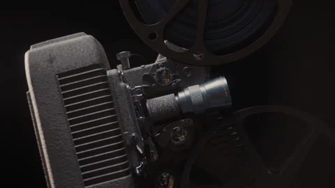Close ups of a vintage 8MM projector spools moving and playing film Stock Footage 301842426
