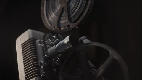 Close ups of a vintage 8MM projector spools moving and playing film Stock Footage 301842481