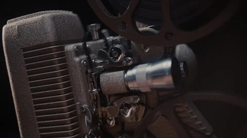 Close ups of a vintage 8MM projector spools moving and playing film Stock Footage 301842683