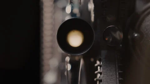 Close ups of a vintage 8MM projector spools moving and playing film Stock Footage 301843202