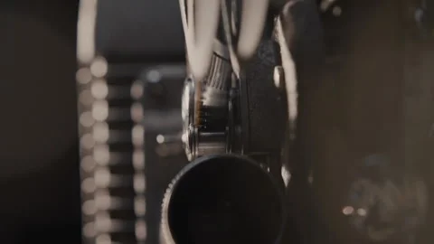 Close ups of a vintage 8MM projector spools moving and playing film Stock Footage 301843449