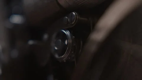 Close ups of a vintage 8MM projector spools moving and playing film Stock Footage 301843658