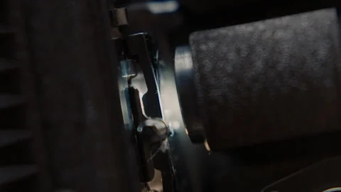 Close ups of a vintage 8MM projector spools moving and playing film Stock Footage 301843876