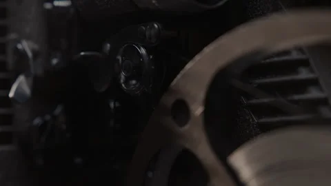 Close ups of a vintage 8MM projector spools moving and playing film Stock Footage 301843931