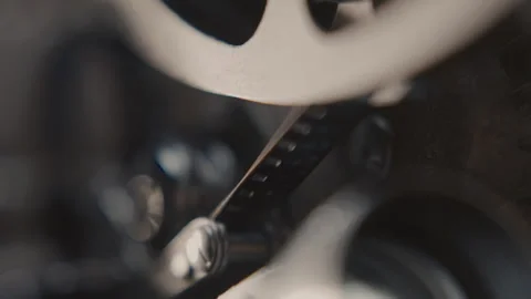 Close ups of a vintage 8MM projector spools moving and playing film Stock Footage 301844408
