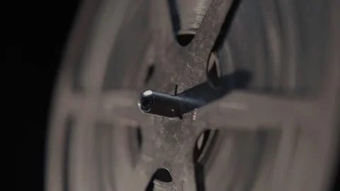 Close ups of a vintage 8MM projector spools moving and playing film Stock Footage 301845041