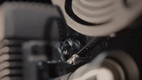 Close ups of a vintage 8MM projector spools moving and playing film Stock Footage 301845142