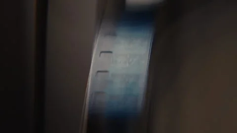 Close ups of a vintage 8MM projector spools moving and playing film Stock Footage 301845386