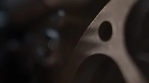 Close ups of a vintage 8MM projector spools moving and playing film Stock Footage 301845815