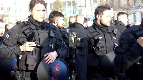Close-ups of young policemen marching on the fringes of the demonstration Stock Footage 120914018