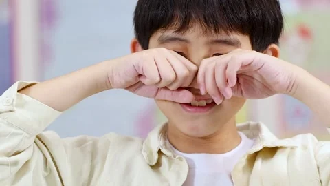 Close-up of Upset Asian Boy Rubbing His Eyes While Crying Stock Footage 325828189