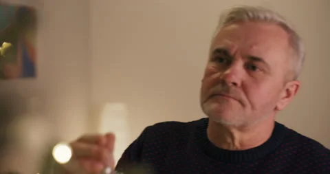 Close-up of upset middle-aged man who is reluctant to decorate Christmas tree 스톡 동영상 210586559