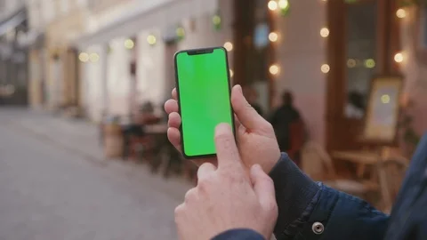 Close-up of urban guy browsing modern application on vertical smartphone Stock Footage 117428685