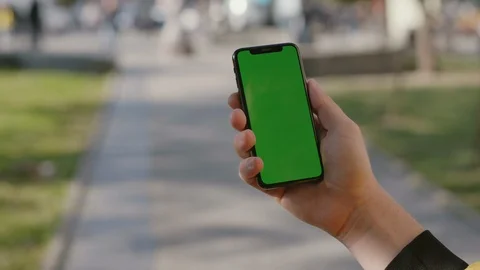 Close-up of urban man typing on vertical greenscreen of modern mock-up Stock Footage 117427674