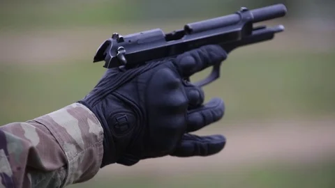 Close up of U.S. Army soldier loading Beretta M9 pistol Stock Footage 82695715