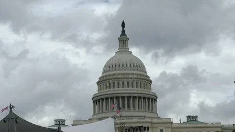 Close-up of U.S. Capitol dome with event setup below Stock Footage 320746053