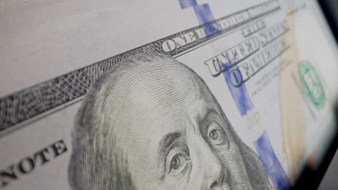 Close-up of US dollar banknotes counted by a cash counting machine. Perfect for Stock Footage 340023331