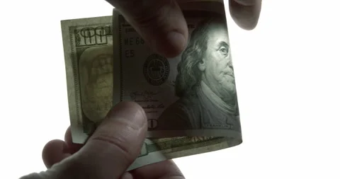 Close-Up of US Dollar Banknotes Exchanged as Bribe in Dramatic Light Stock Footage 341446263