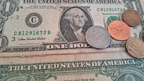 Close-up of US dollar bills and coins, financial growth concept. Business and Stock Photos