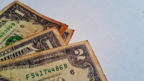 Close-up of US dollar bills on a white surface. Financial success and money Stock Photos