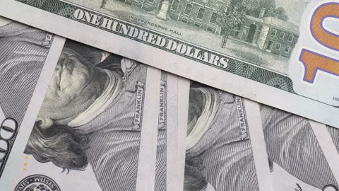 Close-up of us dollars. a lot of hundred dollar bills rotate in a circle slow mo 動画素材 233489332