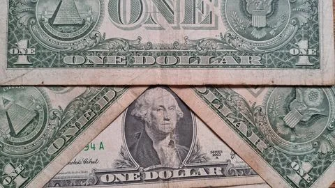 Close-up of US one dollar bills showing detailed currency design. Focus on Stock Photos