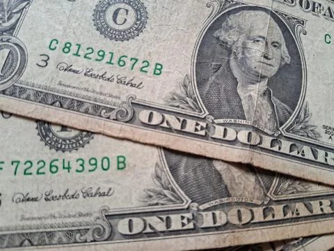 Close-up of US one dollar bills showing detailed currency design. Focused shot Stock Photos