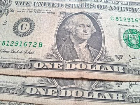 Close-up of US one dollar bills showing detailed currency design. Financial Stock Photos