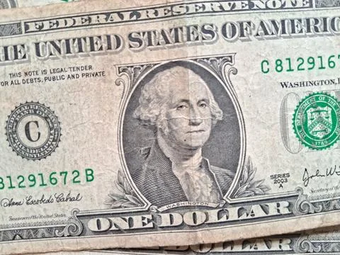 Close-up of US one dollar bills showing detailed currency design. Financial Stock Photos