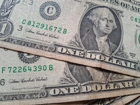 Close-up of US one dollar bills showing detailed currency design. Financial Stock Photos