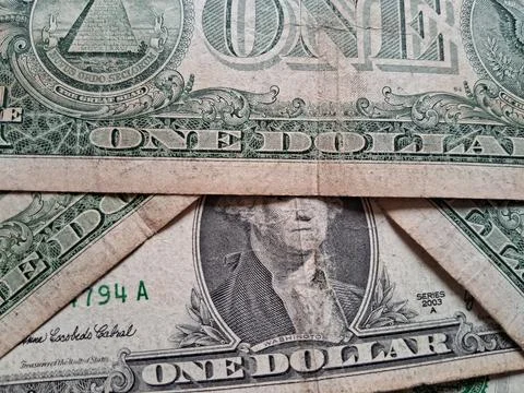 Close-up of US one dollar bills showing detailed currency design. Financial Stock Photos
