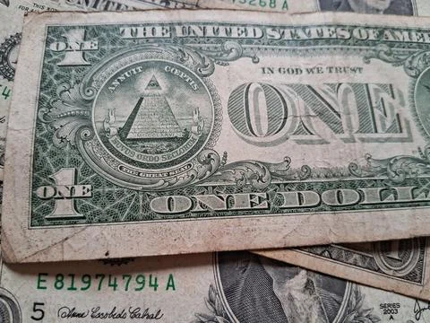 Close-up of US one dollar bills showing detailed currency design. Focus on Stock Photos