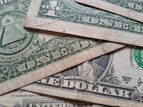 Close-up of US one dollar bills showing detailed currency design. Financial Stock Photos