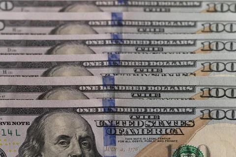 Close-up of US one hundred dollar bills stacked in diagonal rows with selec.. Stock Photos