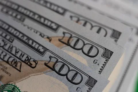 Close-up of US one hundred dollar bills stacked in diagonal rows with selec.. Stock Photos