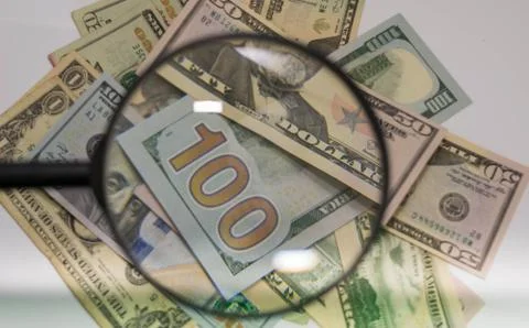 Close up of USA banknotes, 100 us dollar note inside zoom of magnifying glass. Stock Photos