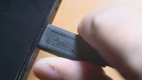 Close-up of USB-C cable plugging and unplugging into smartphone charging port Stock Footage 345506121
