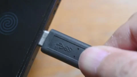 Close-up of USB-C cable plugging and unplugging into smartphone charging port Stock Footage 345506131