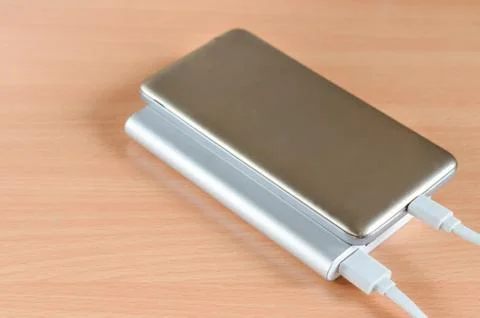 Close-up of usb  fast charge power bank charging a smartphone . Stock Photos