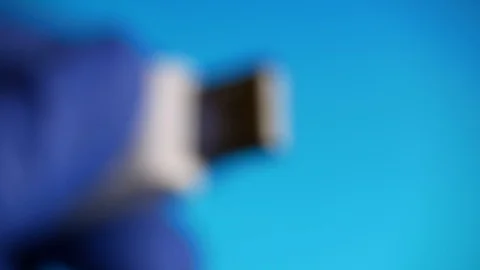 Close-up of USB flash drive memory card is in the blue gloves on blue background Stock Footage 129443554