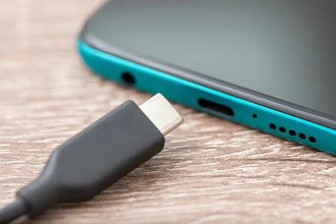 Close up of USB type-c connector near smartphone Stock Photos