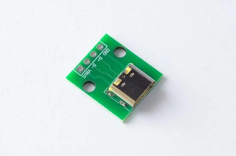 Close-up of a USB Type-C power connector module mounted on a green PCB, isola Foto stock
