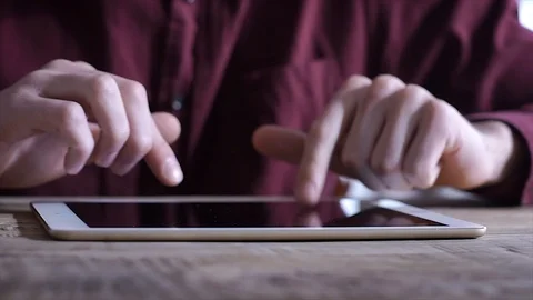 Close-up: the use of the tablet. A man at a business meeting uses a Tablet Stock Footage 105319347