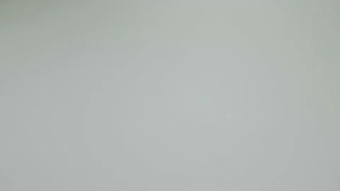 Close-up used condom falling on white table at white background. Tied Stock Footage 172677236
