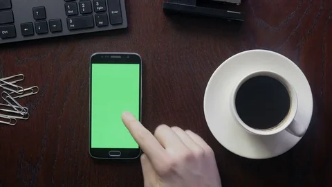 Close-up of using an app on a phone with a green screen at the office Stock Footage 73260205