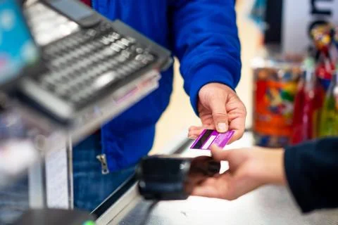 Close up of using credit card pos terminal to pay. Hands inserting the Stock Photos