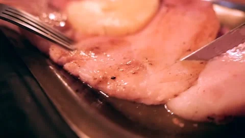 Close-up of using a fork and knife to cut a steak Stock Footage 171360534