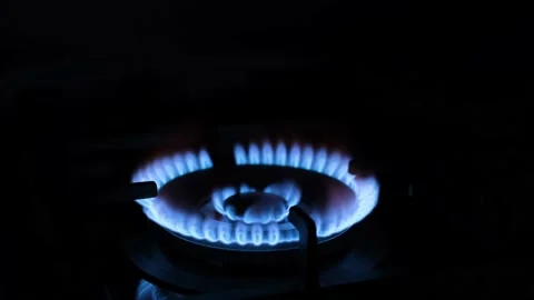 Close-up of using gas for cooking. the gas stove burns in the dark. Stock Footage 233892899