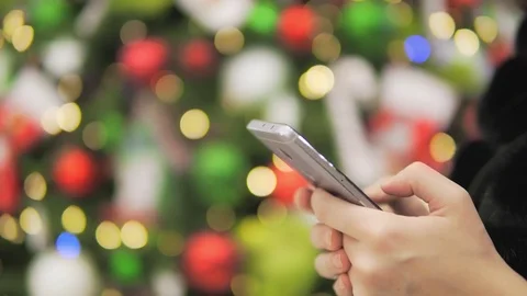 Close-up of using a mobile phone against a background of lights. Stock Footage 83993733