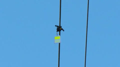 Close-Up of Utility Drone Attached to Power Line Conductor Stock Footage 346307725